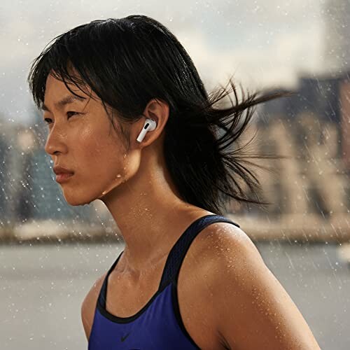 Person wearing earbuds running in the rain